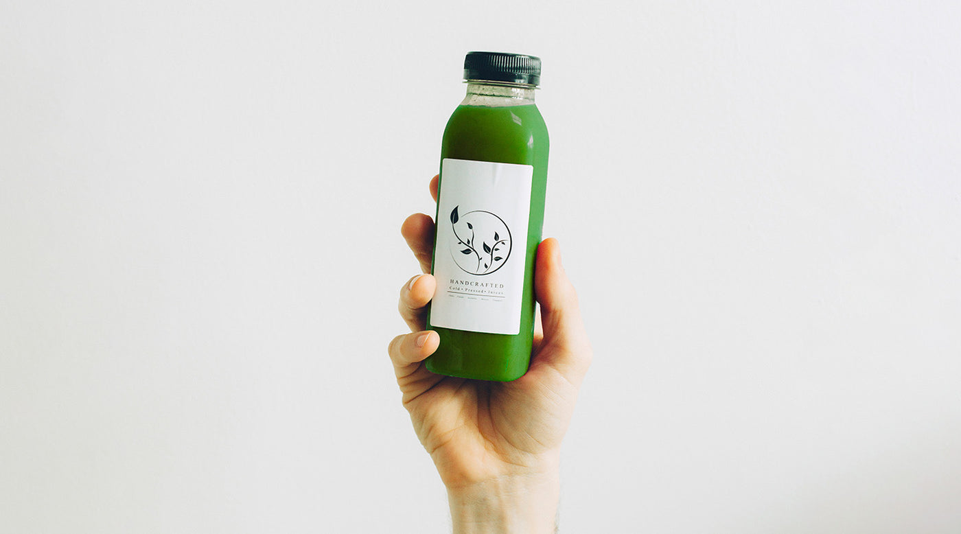 Matcha RTD beverage in plastic bottle held up in front of white background