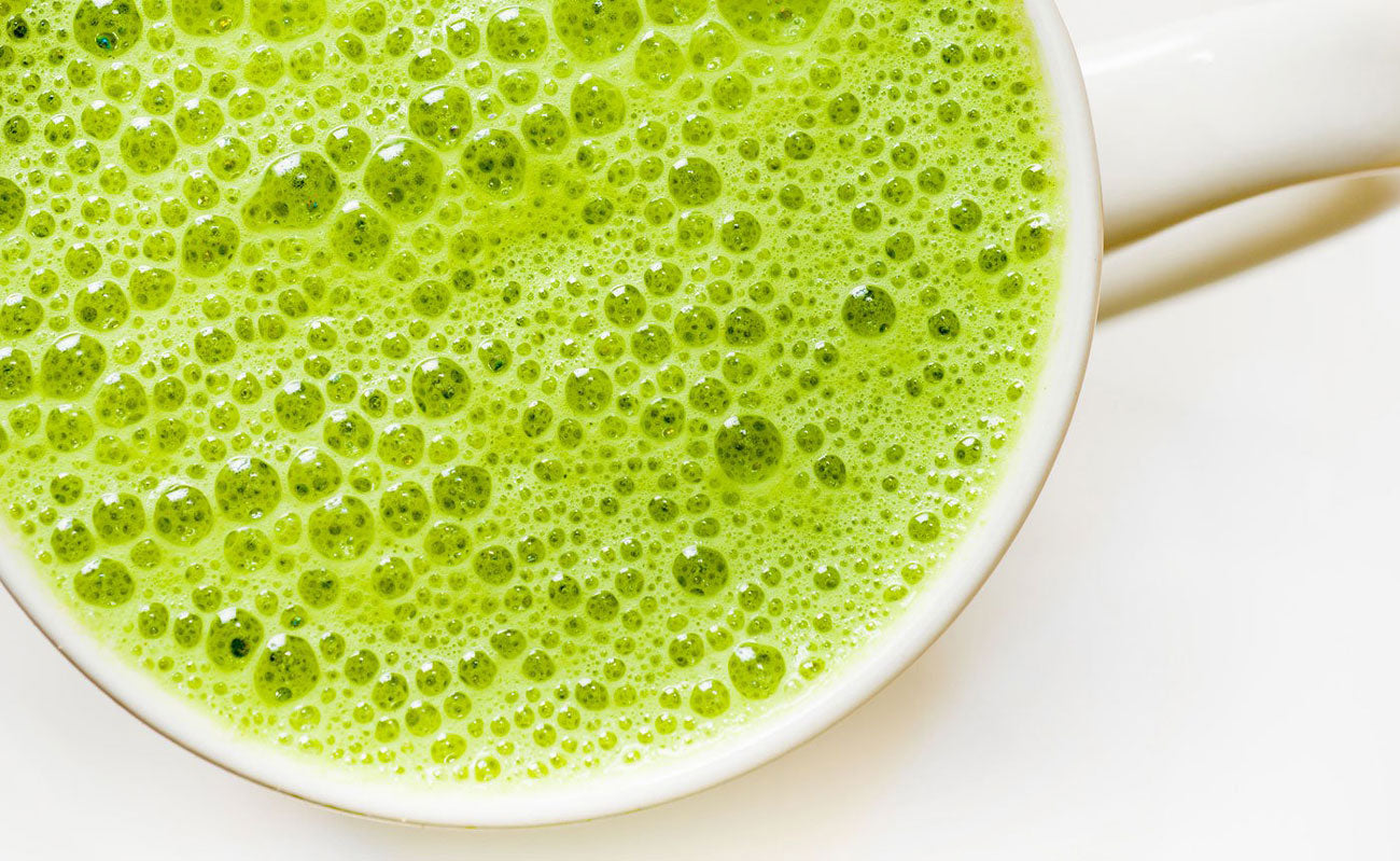 A frothing matcha tea latte